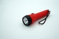 A small red flashlight on a white isolated background Royalty Free Stock Photo