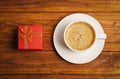 Small red gift box and cup of coffee Royalty Free Stock Photo