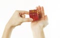 Red gift in gentle hands of a young girl, on a white isolated background Royalty Free Stock Photo