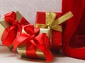 Small red and golden boxes with gifts tied bows Royalty Free Stock Photo