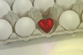Small red heart in a white egg shell on a blue background Royalty Free Stock Photo