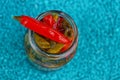 Small red canned pepper on a glass jar Royalty Free Stock Photo