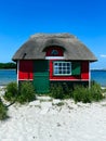 Small red house at the beach on the island of Aero in Denmark Royalty Free Stock Photo