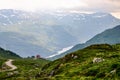 A small red house on the horizon above the deep and narrow fjord in Norway, Europe Royalty Free Stock Photo