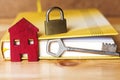 small red house with key, padlock and book, sell house business concept. Royalty Free Stock Photo