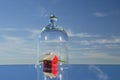 Small red house model in glass bell on mirror in space Royalty Free Stock Photo