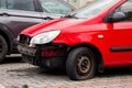 A small red Hyundai Getz hatchback car with missing frontal par after a traffic accident with cooler, radiator visible and Royalty Free Stock Photo