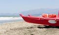 Small red life guard vessel is parking next to the sea Royalty Free Stock Photo