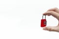 Small Red Lock In Hand on White Background. Hand holding small combination lock. Security Concept