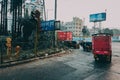 Small red lorry truck delivery on mumbai crowded turn street with rikshaws Royalty Free Stock Photo