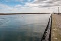 A small red motorboat heads out to sea on a calm day Royalty Free Stock Photo