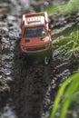 Small red off road car toy in the nature Royalty Free Stock Photo