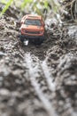 Small red off road car toy in the nature. Royalty Free Stock Photo