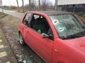 Den bosch, The Netherlands, 25-12-2019: a small red peugot with smashed in windows of which the glass has been shattered around Royalty Free Stock Photo