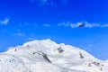 Small red plane flying among clouds over snow peaks and glaciers Royalty Free Stock Photo