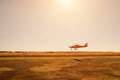 Small red plane in low pass over airstrip Royalty Free Stock Photo