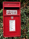 Small red post box on metal post Royalty Free Stock Photo