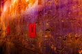 Small red poster with Chinese script hanging on a wall