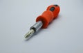 Small red screwdriver, isolated on the gray white background. Royalty Free Stock Photo