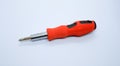 Small red screwdriver, isolated on the gray white background. Royalty Free Stock Photo