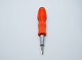 Small red screwdriver, isolated on the gray white background. Royalty Free Stock Photo