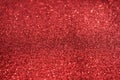 Small red sequins as background. Glitter as a background of the holiday. Beautiful red background