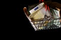 Small red shopping basket full of euro banknotes. Finance. Financial crisis. Banking system. Economic problem. Inflation. Royalty Free Stock Photo