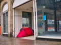 A small red tent pitched in the doorway of a closed shop in Preston, Lancashire in the north west of the UK