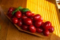 Small red tomatoes in basket on an wooden table , selective focus Royalty Free Stock Photo