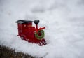 A small toy train stands in the fluffy snow Royalty Free Stock Photo