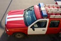 Small red white fire engine with warning lightbar and a ladder on the roof on a sunny day. Mini machinery for extinguish small Royalty Free Stock Photo