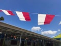 Small red and white flags against a blue sky background. Indonesian independence day celebration. Royalty Free Stock Photo