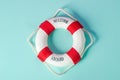 Small red and white lifebuoy on blue background Royalty Free Stock Photo