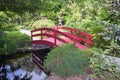 A Small Red Wooden Bridge in a Japanese Garden Royalty Free Stock Photo