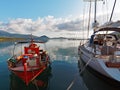 Red Greek Fishing Boat and Modern Yacht Royalty Free Stock Photo