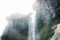 Small refreshing drops fall at Joengbang waterfall in Seogwipo, Jeju Island, South Korea Royalty Free Stock Photo