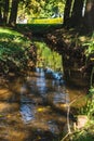 a small regulated stream flowing through the park Royalty Free Stock Photo