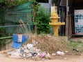 A small religious shrine stands in a garbage dump in Cambodia