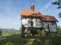 Small renovated baroque chapel above village Marenice in Lusitian mountains with lush green grass meadow, deciduous and Royalty Free Stock Photo