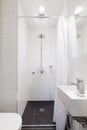 Small renovated white ensuite with rain shower Royalty Free Stock Photo