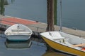 Small rental boats docked along wooden walkway out on water