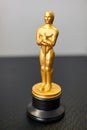 A small replica of the Oscar figure. A symbol of achievements in cinema. Selective focus Royalty Free Stock Photo