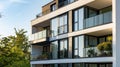 A small residential building with several apartments with a white facade and open glass balconies Royalty Free Stock Photo