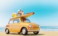 Small retro car with baggage, luggage and beach equipment on the roof, fully packed, ready for summer vacation, concept of a road Royalty Free Stock Photo