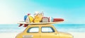 Small retro car with baggage, luggage and beach equipment on the roof, fully packed, ready for summer vacation Royalty Free Stock Photo