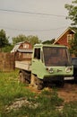 Small retro green truck near the fence