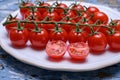 Small ripe red sweet cherry tomatoes on twig Royalty Free Stock Photo