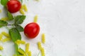 small ripe tomatoes, fresh basil ,pasta top view flat lay frame Royalty Free Stock Photo