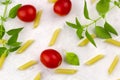 Small ripe tomatoes, fresh basil ,pasta top view Royalty Free Stock Photo