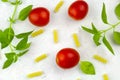 Small ripe tomatoes, fresh basil ,pasta top view Royalty Free Stock Photo